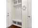 Mud room with built in storage bench, hooks and shelves near the front door at 9849 Steele Meadow Rd, Charlotte, NC 28273