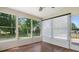 Relaxing sunroom features wood-look floors, ceiling fan, and sliding doors to the outside at 9849 Steele Meadow Rd, Charlotte, NC 28273