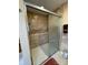 Modern bathroom shower with patterned tile walls, sliding glass doors, and accessible grab bars at 1025 Bee Line Ln, Salisbury, NC 28147