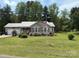 Charming single-story home featuring a metal roof, lush lawn, and a welcoming front porch at 1025 Bee Line Ln, Salisbury, NC 28147