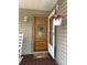 Inviting front door area with hanging plants and a lovely hello door mat at 1025 Bee Line Ln, Salisbury, NC 28147