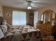 Spacious primary bedroom boasting hardwood flooring and a large dresser with mirror at 1025 Bee Line Ln, Salisbury, NC 28147