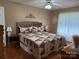Well-lit primary bedroom featuring a comfortable queen size bed and hardwood floors at 1025 Bee Line Ln, Salisbury, NC 28147