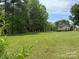 Lush green lawn surrounds this home with an expansive yard with mature trees, providing privacy at 1025 Bee Line Ln, Salisbury, NC 28147