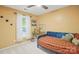 Cozy bedroom featuring a blue daybed, unique decor, and natural light from the window at 105 Horsestable Ct, Mooresville, NC 28115