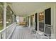 Inviting screened-in porch with rocking chairs and a porch swing at 105 Horsestable Ct, Mooresville, NC 28115