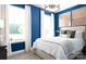 Comfortable bedroom with large windows, blue accent wall and stylish lighting fixture at 105 Nighthawk Trl # 20, Mooresville, NC 28115