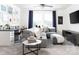 Versatile bonus room with a large gray sectional, desk, TV, and ample natural light for relaxation and productivity at 107 Nighthawk Trl # 21, Mooresville, NC 28115