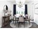 Bright dining room featuring a round table, modern chandelier, elegant decor, and plenty of natural light at 107 Nighthawk Trl # 21, Mooresville, NC 28115