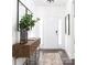 Inviting entryway features a white door, hardwood floors, console table, modern decor, and natural lighting at 107 Nighthawk Trl # 21, Mooresville, NC 28115