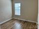A bedroom that features wood-look floors and a window at 1156 Fowler Brook Ct, Indian Land, SC 29707