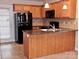 Kitchen with stainless steel appliances, wooden cabinets, and island at 1156 Fowler Brook Ct, Indian Land, SC 29707