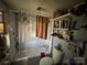 Modest bathroom showcasing a shower-tub combo with curtain, shelving, and standard fixtures at 1210 Congress St, Gastonia, NC 28054