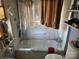 Modest bathroom showcasing a shower-tub combo with curtain, shelving, and standard fixtures at 1210 Congress St, Gastonia, NC 28054