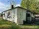 White siding home exterior with a small covered front porch, showing signs of needed repair and cleanup at 1210 Congress St, Gastonia, NC 28054