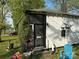 Exterior showcasing the home's weathered facade and foliage covered supports at 1210 Congress St, Gastonia, NC 28054