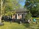 Charming single-story house featuring a cozy screened-in porch and a sprawling green lawn at 1210 Congress St, Gastonia, NC 28054