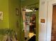 Hallway leading to the kitchen featuring a vintage refrigerator and a view of the dining area at 1210 Congress St, Gastonia, NC 28054