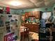 Kitchen featuring vintage cabinets, appliances, and an adjacent dining area with a table set for a meal at 1210 Congress St, Gastonia, NC 28054