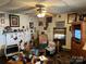Living room includes lots of vintage decorations, chairs, and a ceiling fan at 1210 Congress St, Gastonia, NC 28054