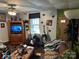 Living room features vintage decor, a ceiling fan, and a large console TV at 1210 Congress St, Gastonia, NC 28054