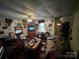 View of the living room showcases a vintage ceiling fan and multiple seating areas at 1210 Congress St, Gastonia, NC 28054