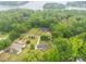 Picturesque aerial view of the property surrounded by lush trees, near a serene lake at 1215 Eastcreek Rd, Fort Lawn, SC 29714