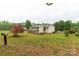 Lush backyard with green grass, mature trees, and a bench to enjoy the view at 1215 Eastcreek Rd, Fort Lawn, SC 29714