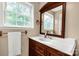 Bathroom featuring a wood vanity, a large mirror, and natural light from a window at 1215 Eastcreek Rd, Fort Lawn, SC 29714