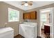 Functional laundry area with washer, dryer, and convenient storage cabinet at 1215 Eastcreek Rd, Fort Lawn, SC 29714
