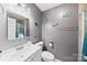 Bathroom with gray walls, white fixtures, and decorative wall art at 123 Carriage House Dr, Kannapolis, NC 28081