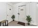 View of apartment entryway with white door, green plants, and 'Welcome-ish' sign at 123 Carriage House Dr, Kannapolis, NC 28081