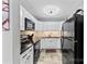 Well-lit kitchen showcasing ample white cabinets, black appliances, granite countertops, and tiled backsplash at 123 Carriage House Dr, Kannapolis, NC 28081
