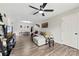 Bright living room featuring hard wood floors, a modern ceiling fan, and a comfy sectional couch at 123 Carriage House Dr, Kannapolis, NC 28081