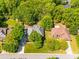 Aerial view of the home featuring mature trees, a well-manicured lawn, and a long driveway at 1257 Mill Race Ln, Matthews, NC 28104