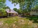 A lovely backyard featuring a screened-in porch, patio, and fire pit for enjoyable outdoor relaxation at 1257 Mill Race Ln, Matthews, NC 28104