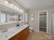 Bright bathroom with double sink vanity, large mirror, and a separate door to toilet and shower at 1257 Mill Race Ln, Matthews, NC 28104