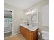 Bathroom with a double sink vanity with wood cabinets and view into attached bedroom at 1257 Mill Race Ln, Matthews, NC 28104