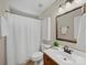 Bright bathroom with a shower-tub combo, neutral colors, updated mirror and modern vanity at 1257 Mill Race Ln, Matthews, NC 28104