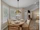 Cozy breakfast nook with large windows and a decorative Tiffany-style lamp, perfect for enjoying meals with Gathering at 1257 Mill Race Ln, Matthews, NC 28104