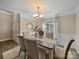 Charming dining room with natural light, featuring elegant lighting and stylish decor for memorable gatherings at 1257 Mill Race Ln, Matthews, NC 28104