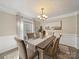 Elegant dining room featuring wainscoting, neutral tones, and an area rug that complement the sophisticated setting at 1257 Mill Race Ln, Matthews, NC 28104
