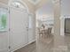Bright foyer with a white front door and hardwood floors leading to dining room at 1257 Mill Race Ln, Matthews, NC 28104