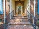 Brick steps lead to an ornate front door, flanked by planters and iron railings at 1257 Mill Race Ln, Matthews, NC 28104