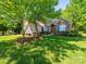 Inviting brick home with a meticulously maintained lawn and beautiful landscaping surrounding the property at 1257 Mill Race Ln, Matthews, NC 28104