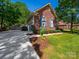 Home exterior with two-car garage, neat landscaping, and beautiful brick and siding at 1257 Mill Race Ln, Matthews, NC 28104