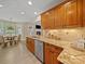 Beautiful kitchen showcasing granite countertops, oak cabinets, and stainless steel appliances with an adjacent breakfast nook at 1257 Mill Race Ln, Matthews, NC 28104
