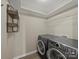 Convenient laundry room with modern washer, dryer and ample shelf space at 1257 Mill Race Ln, Matthews, NC 28104