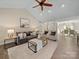 Neutral living room with vaulted ceilings, plenty of seating, and an open floor plan at 1257 Mill Race Ln, Matthews, NC 28104