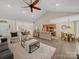 Spacious living area with vaulted ceilings, a fireplace, and seamless flow into the kitchen and dining areas at 1257 Mill Race Ln, Matthews, NC 28104